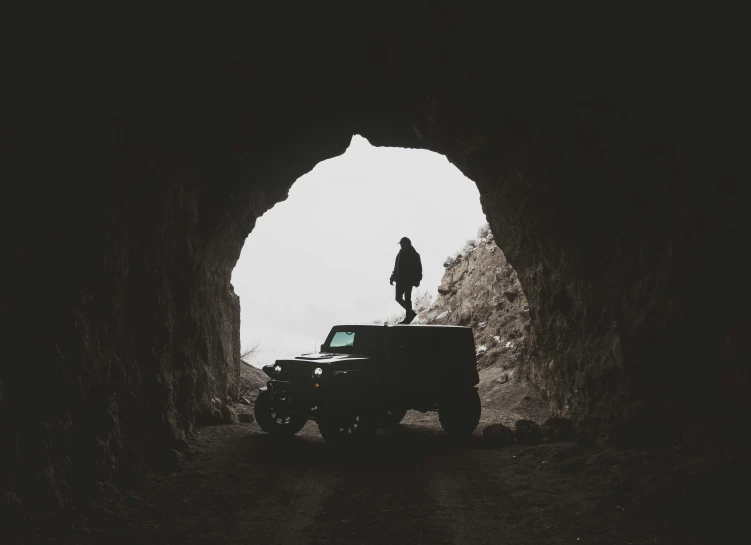 a person standing on top of a black jeep