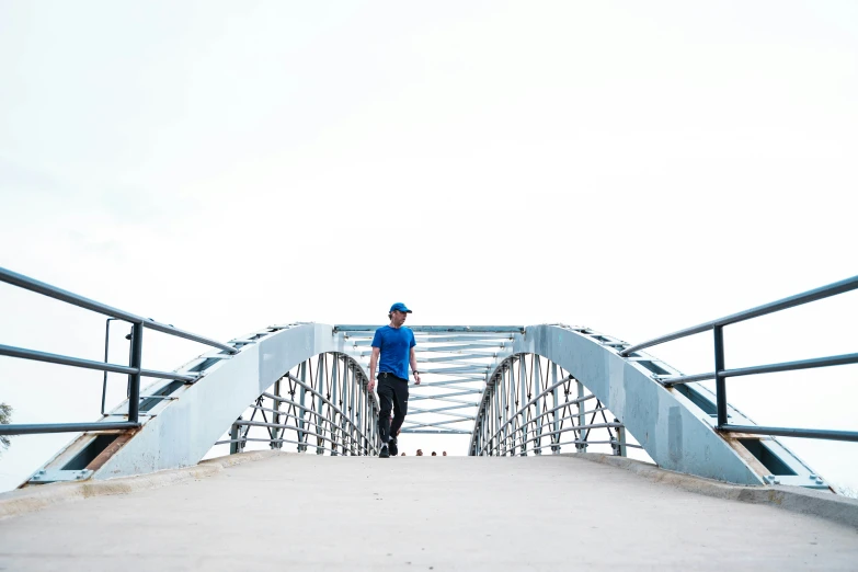 a person standing on a bridge looking down at soing