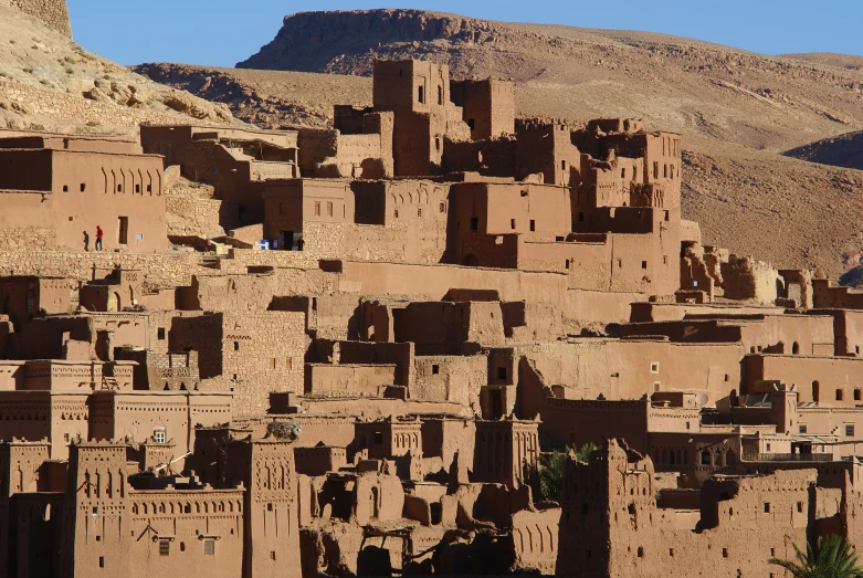 large, adobe - style village with mountains in the background