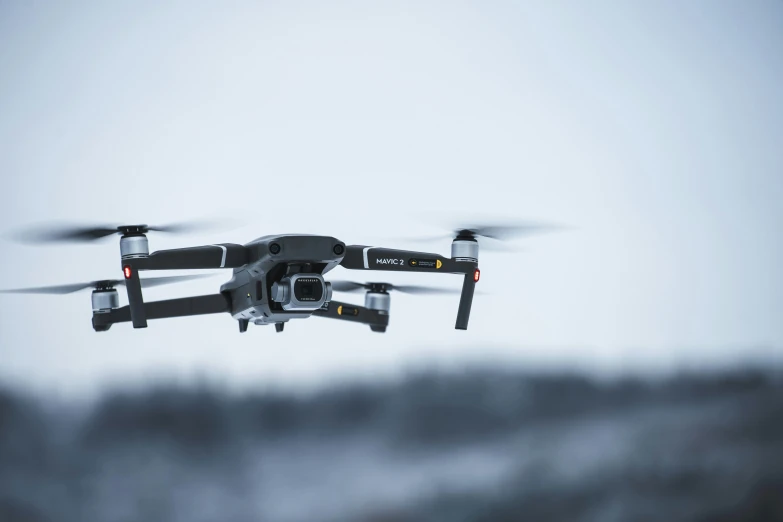 a close up of a black and white pograph of a small flying device