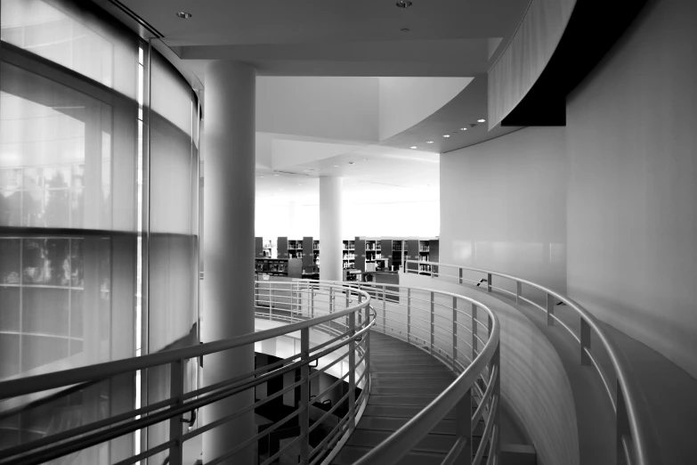 an empty building has a curved stairway next to it