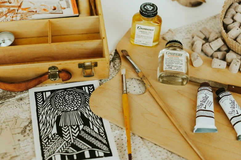 an open wooden box that is holding a couple of ink bottles