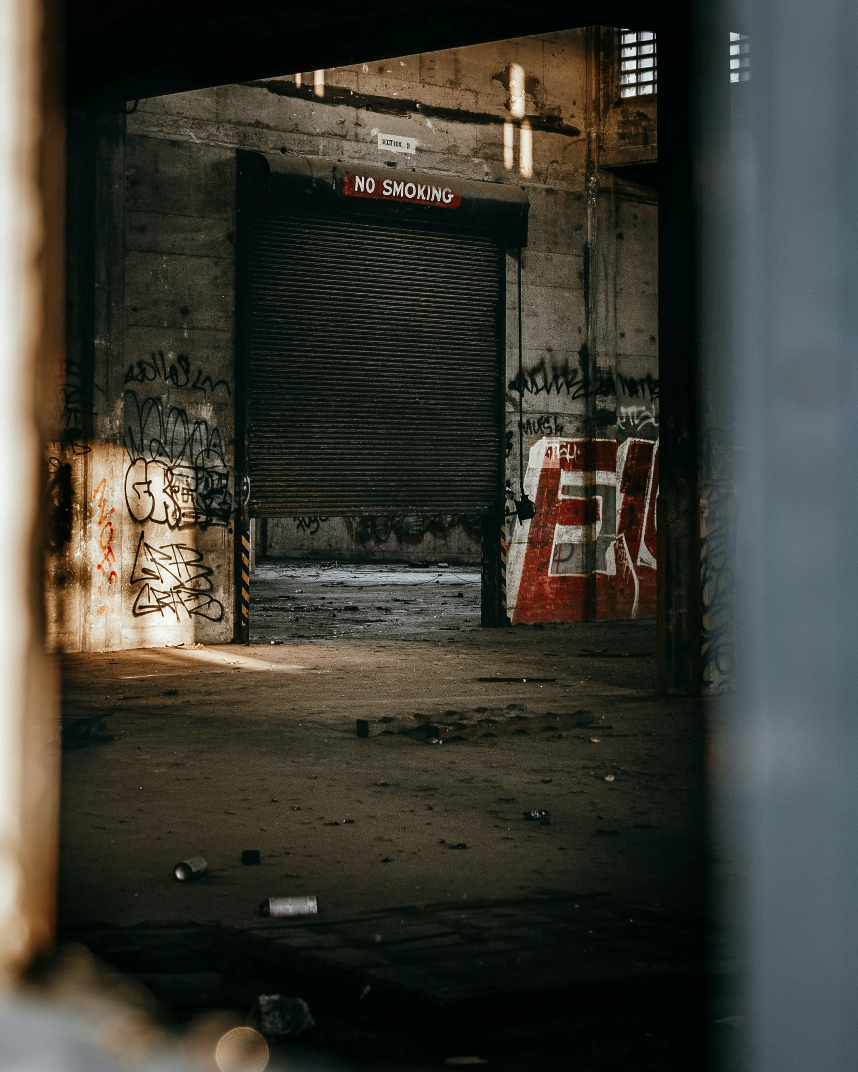 a run down garage door with graffiti written on it