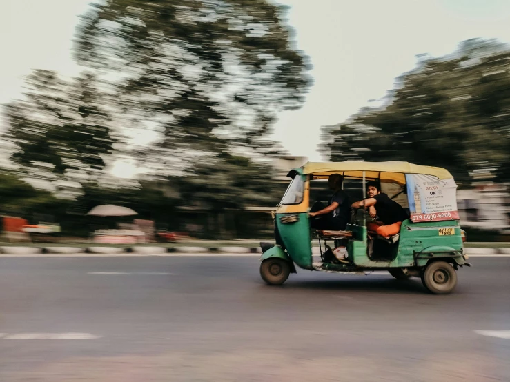 a small vehicle is driving on the road