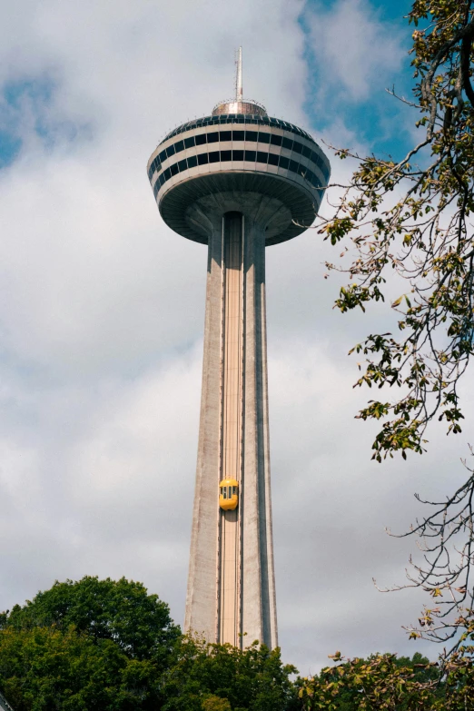 an image of a tower in the sky with clouds