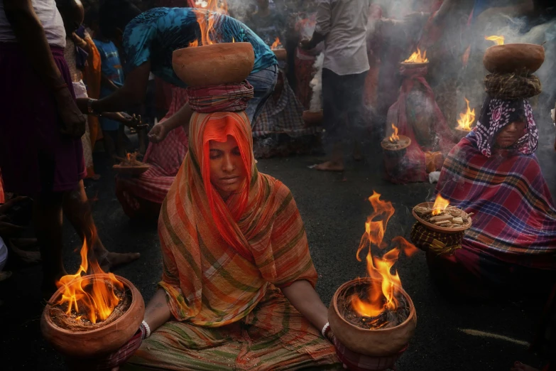 many people around with burning baskets in their hands