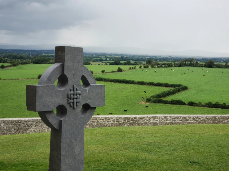 a concrete sculpture that is standing on a field