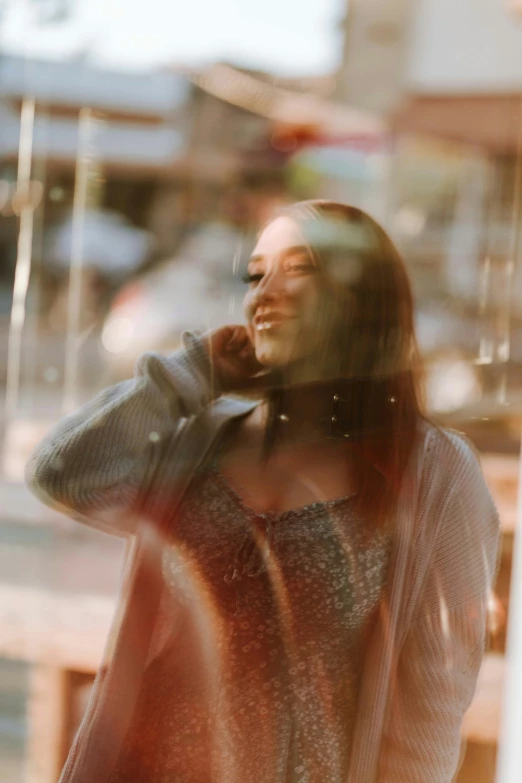 the reflection of a woman talking on a cell phone