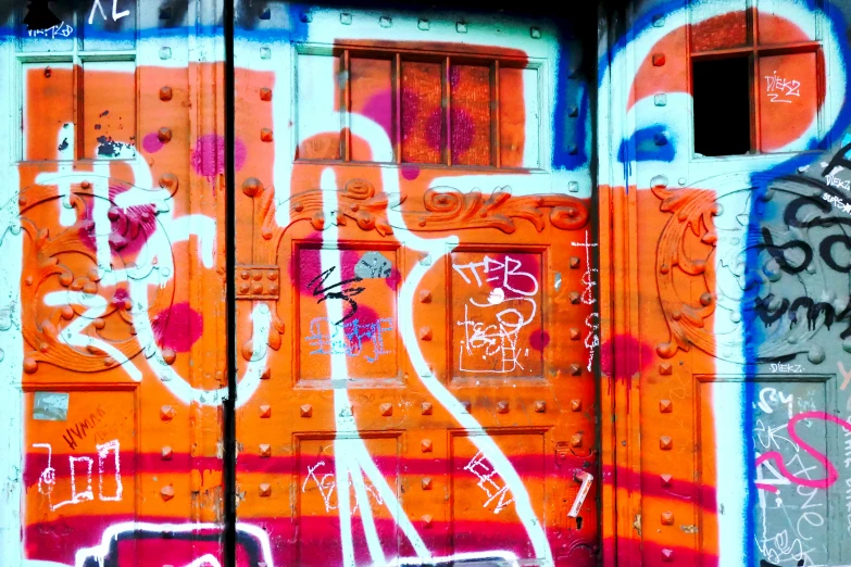 orange, purple and white graffiti on a building