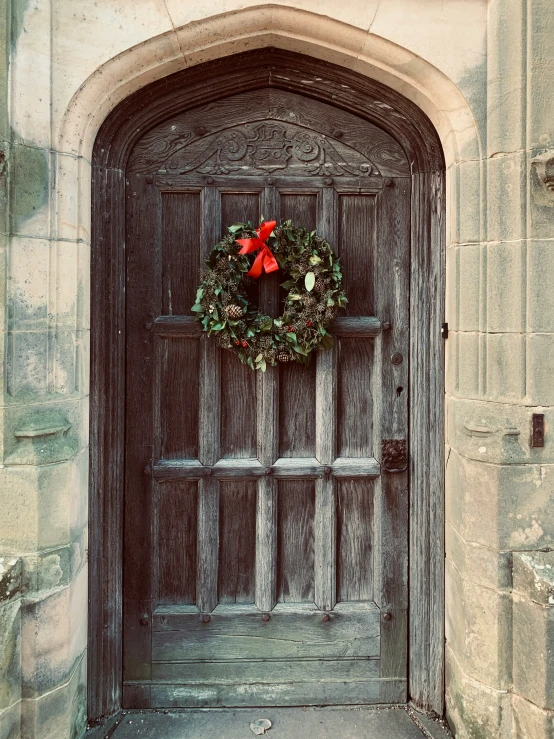 an old stone building with a wreath on it