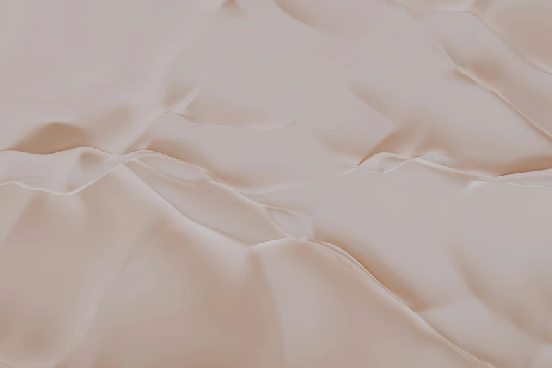 the surface of an unmade bed with wrinkled sheets