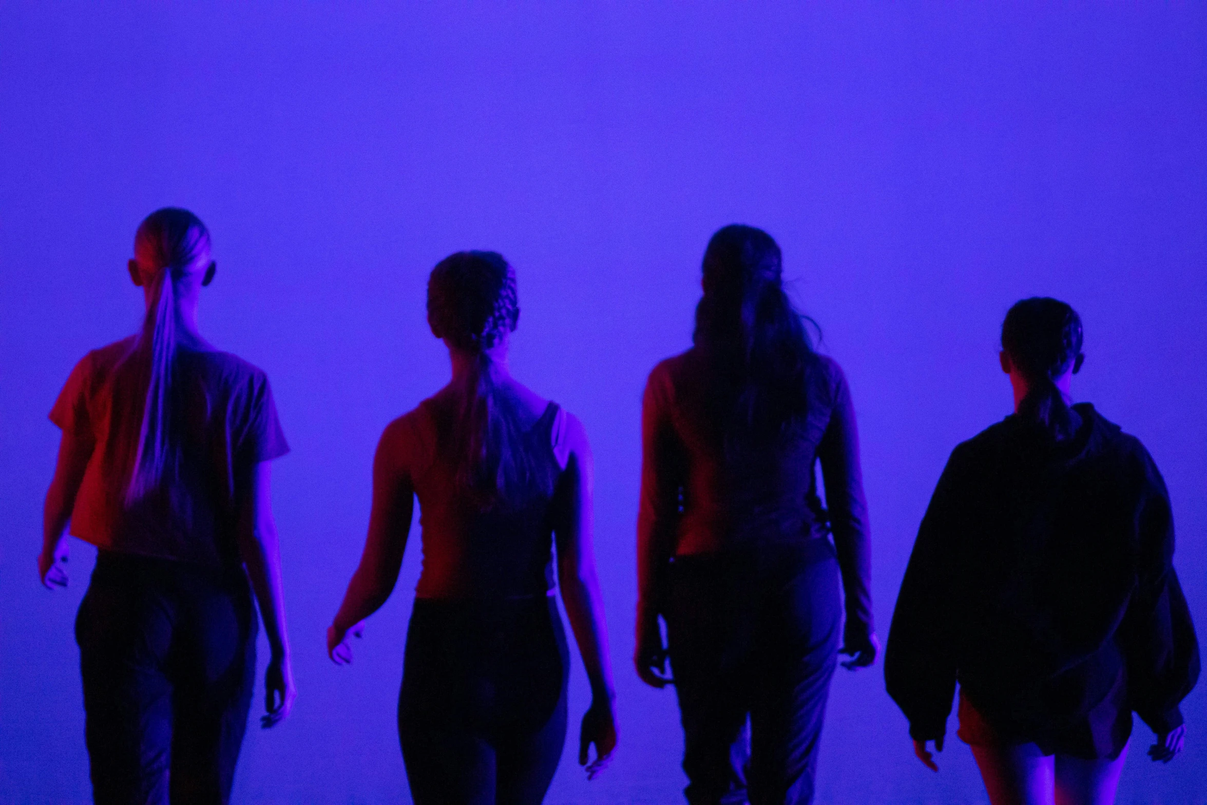 a group of people walking through a dark room