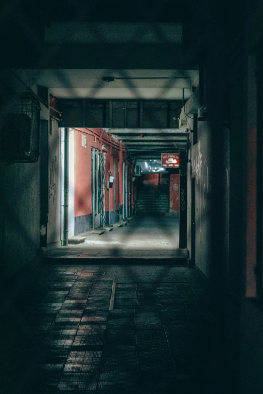 an empty, dark hallway is lit by a bright light