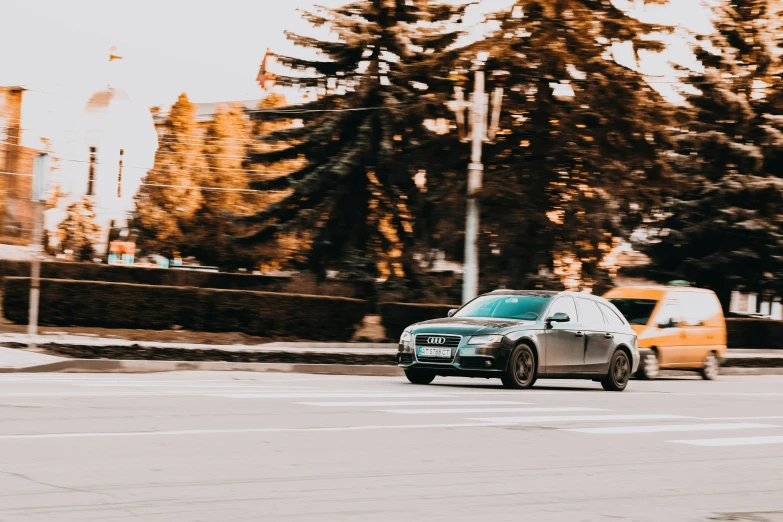 a car is traveling down the street on the corner