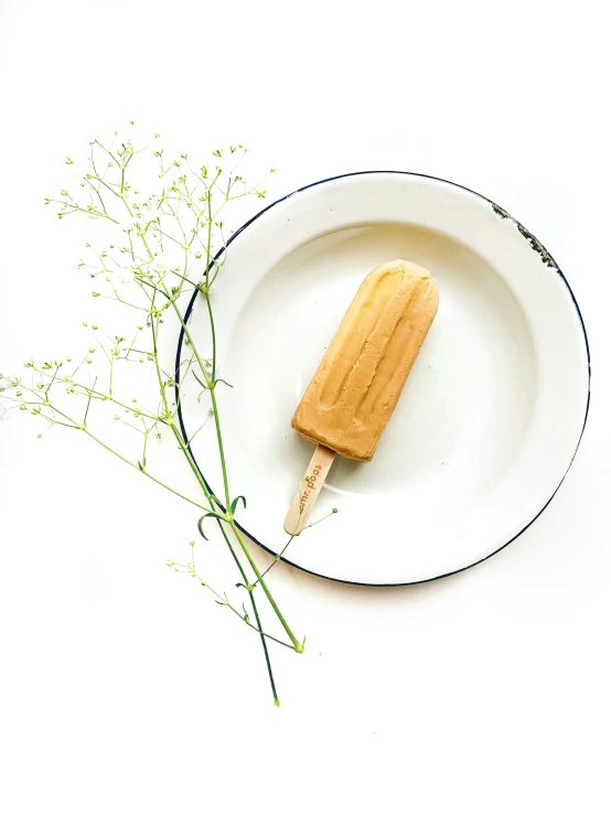 a wooden stick is placed on a white plate