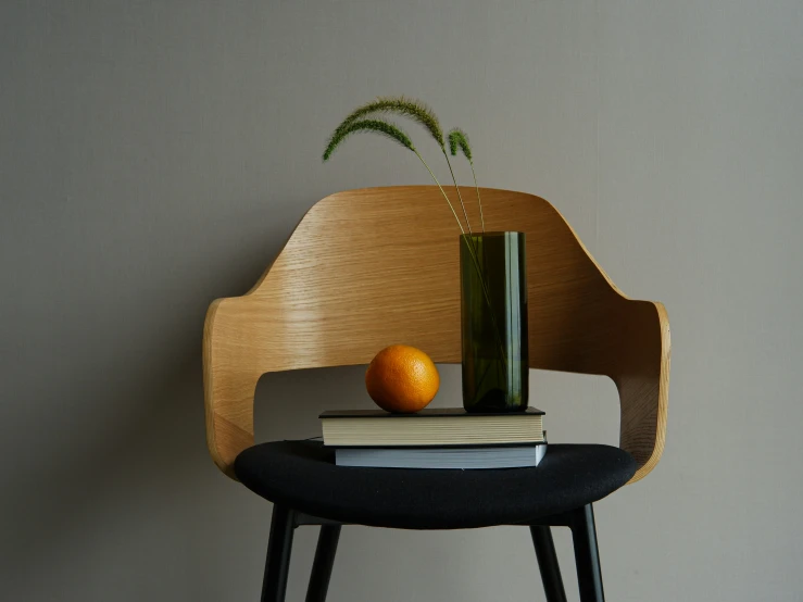 a chair that has a bottle of wine on top of books