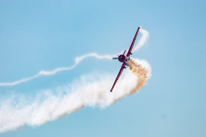 two airplanes with smoke coming from it that are leaving trails