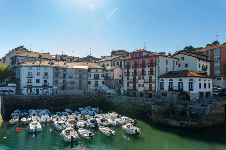 many boats in the water near buildings