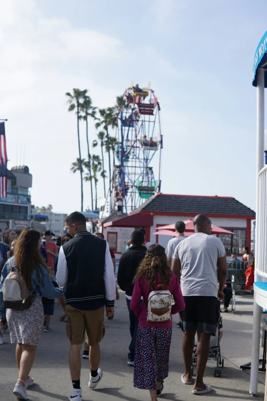 some people walking and riding around on a fair ride