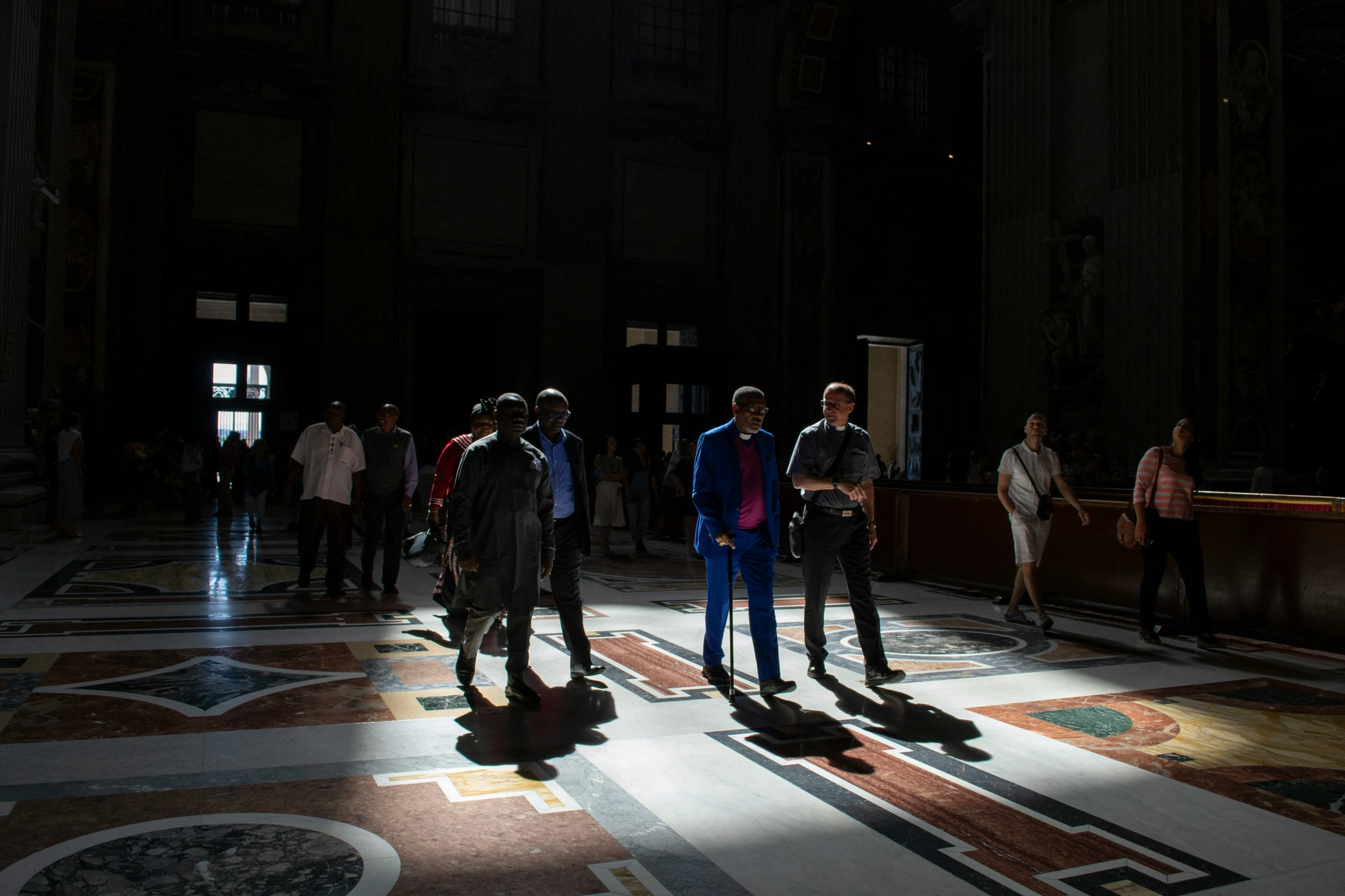 a group of people standing on either side of a building