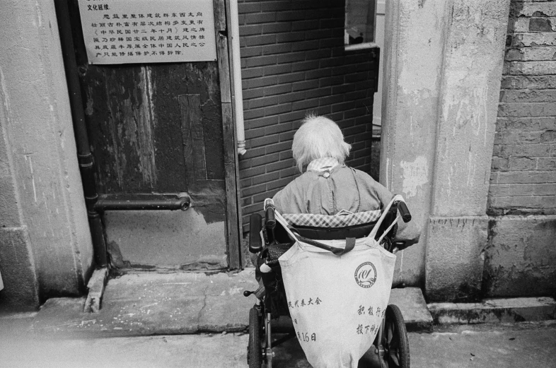 a person on a motor bike parked on the sidewalk