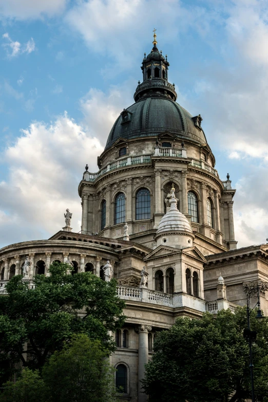 a large building with a domed top that has a clock on it