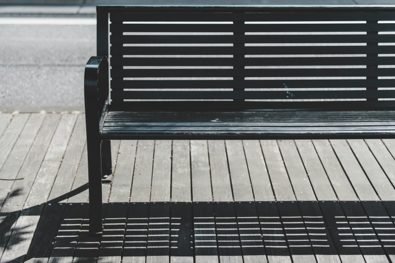 the wood bench is empty on the boardwalk