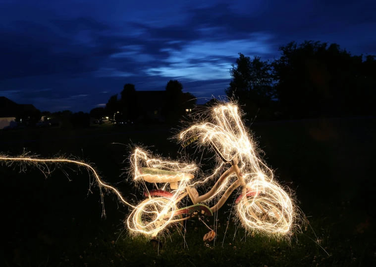 a bicycle is decorated with christmas lights in a park