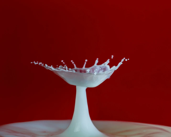 a red and white image of a splashing liquid