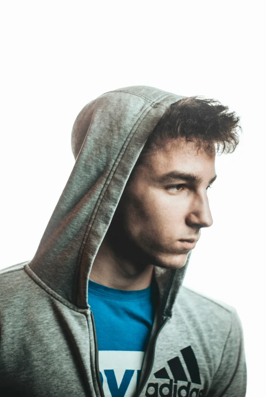 a man with a hoodie on looking away