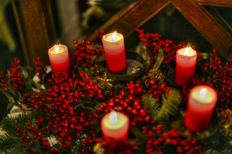 lighted candles with christmas decorations around