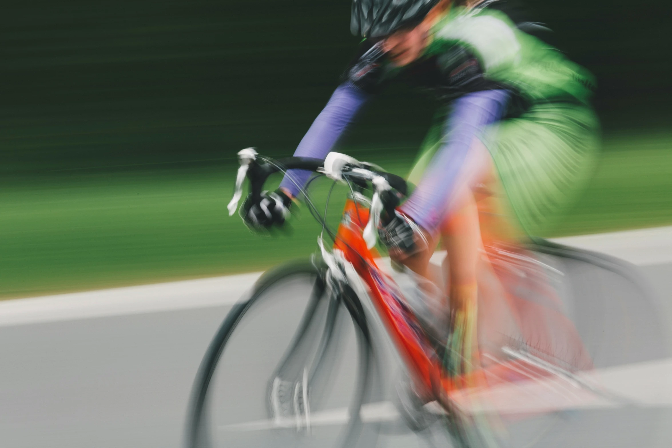 person on a bike passing through a blurry po