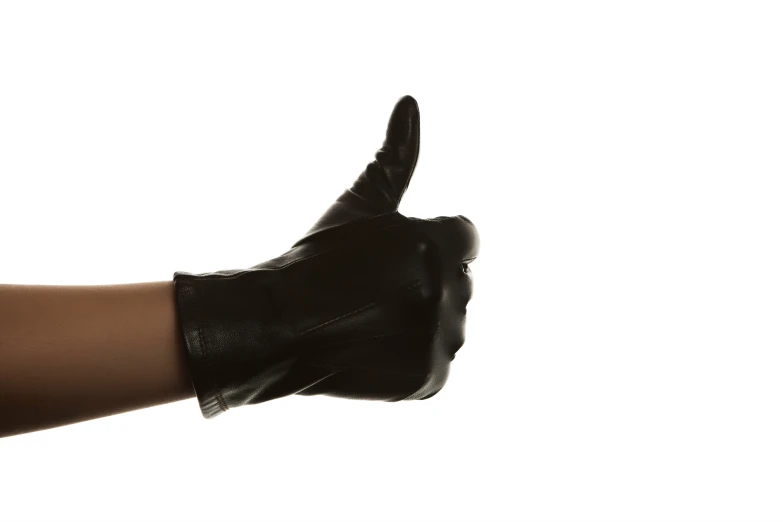 a hand in black leather has a black glove