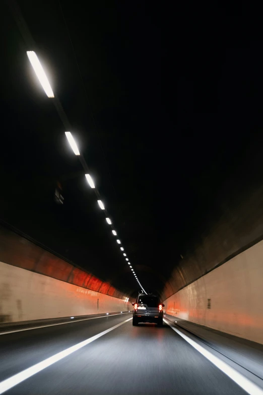 some cars going through a tunnel with lights on