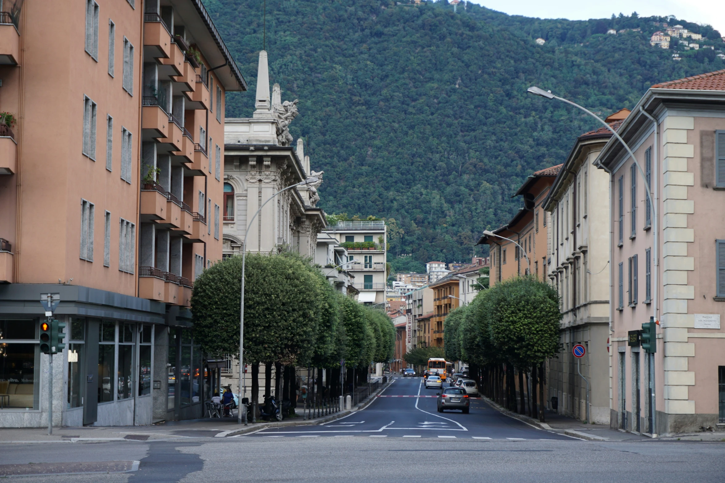 a city street in front of mountains with buildings