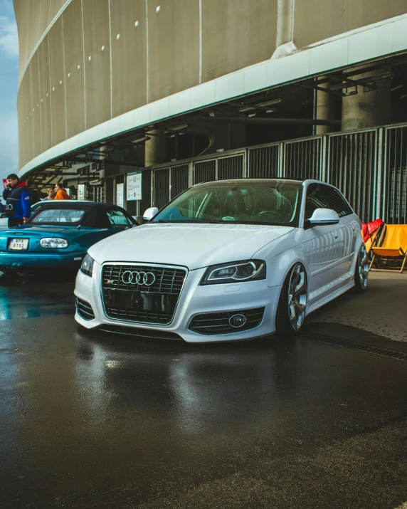 two cars parked in front of an airport terminal