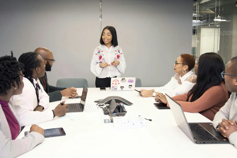 a business woman speaking to her group in front of him