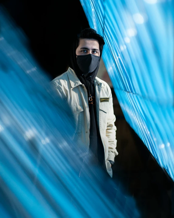 a man standing behind a curtain in black and white