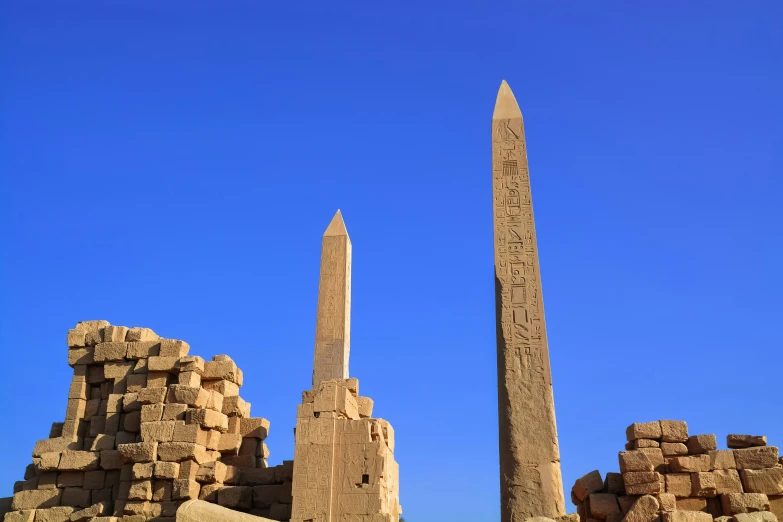 a couple of tall stone pillar in a field