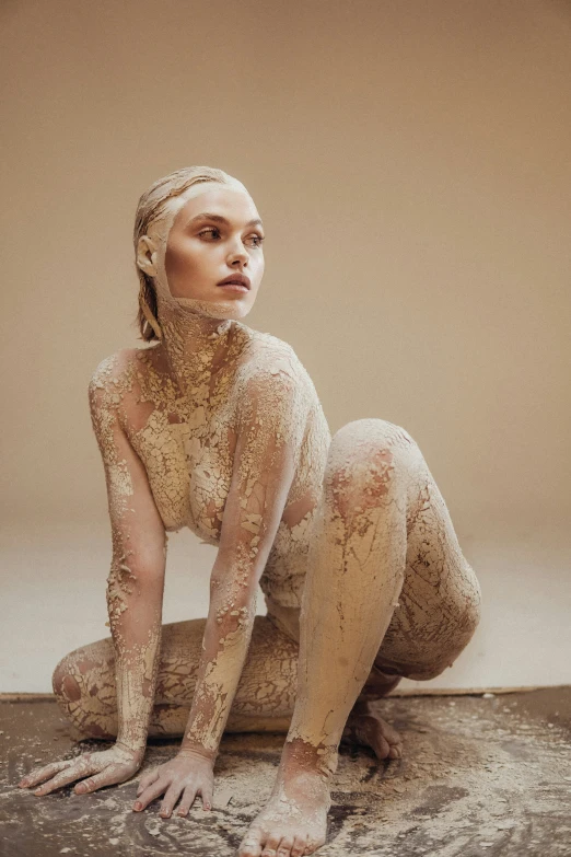 woman covered in white body paint with white background