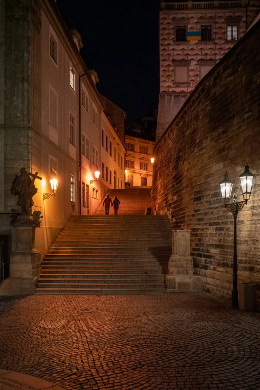 a man and a woman are walking up some stairs