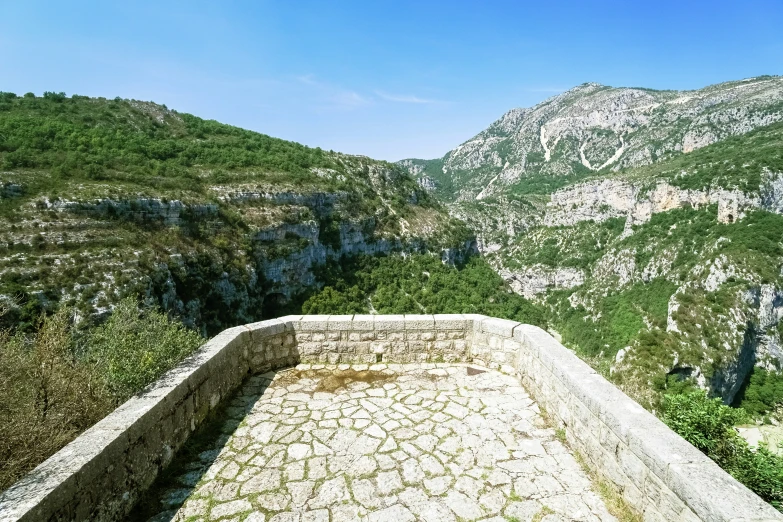 view from the top of a small hill, above some mountains