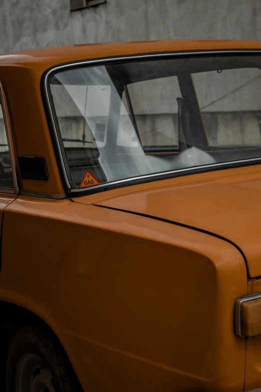 an orange vehicle parked on the side of a street