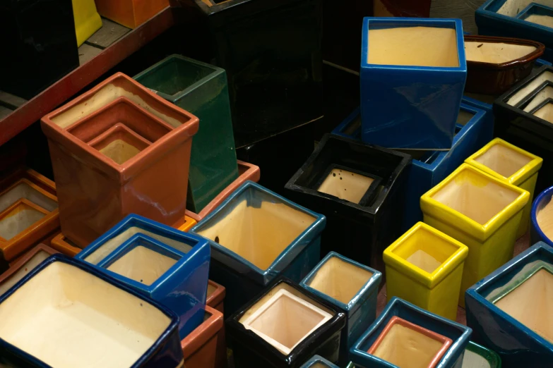 a table with many colors of pigments arranged in different boxes