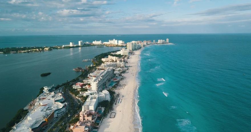 a panoramic view of a beach and ocean near a city