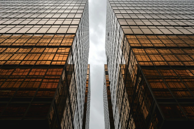 some tall buildings with metal balconies against a cloudy sky