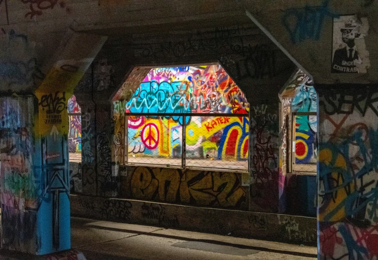 a train traveling past graffiti covered windows