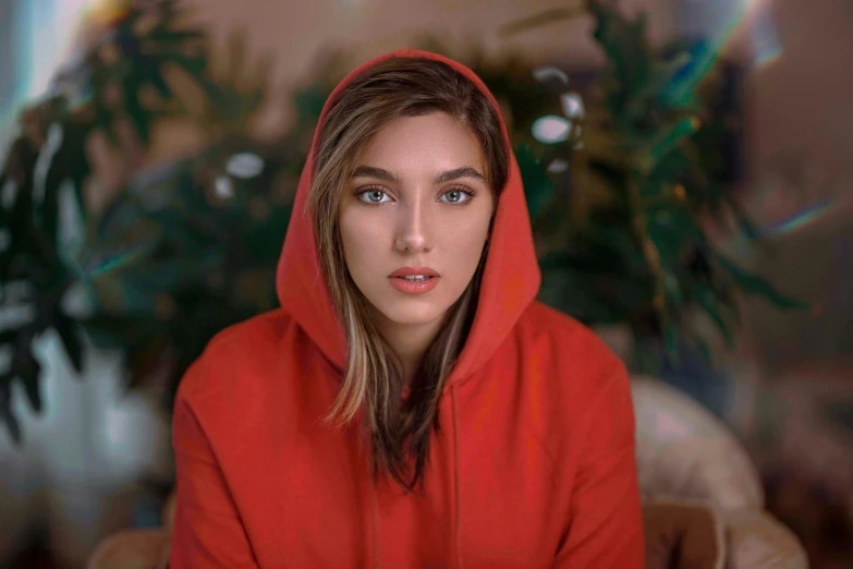 a woman with a red hoodie looking away