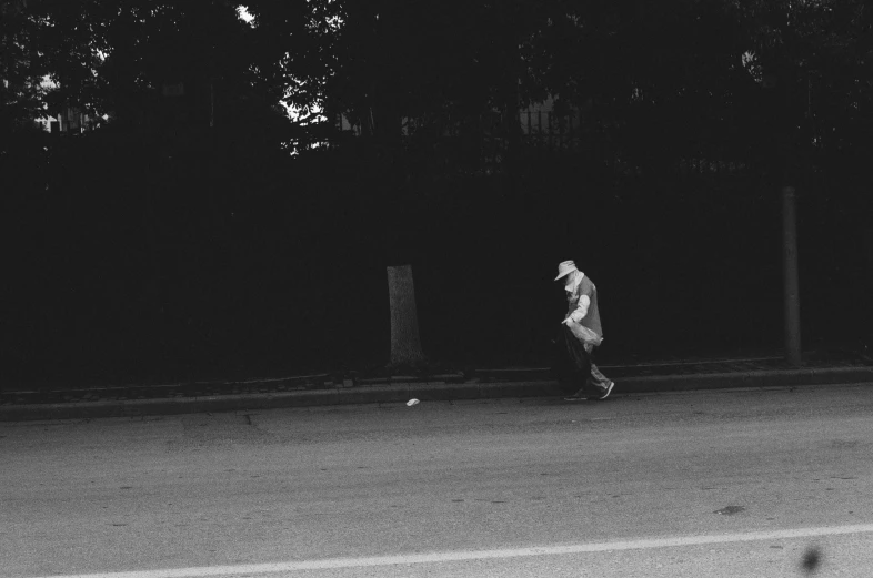 a man is riding his skateboard across the road