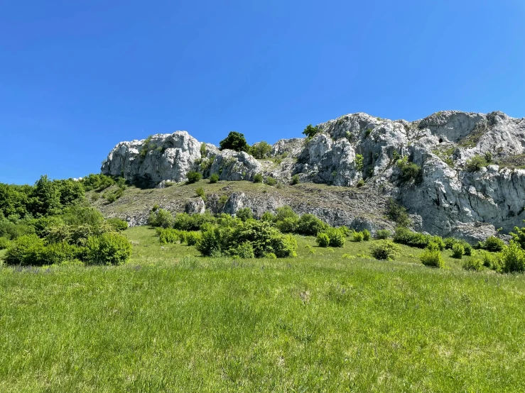 the mountains are covered in rocks and grass